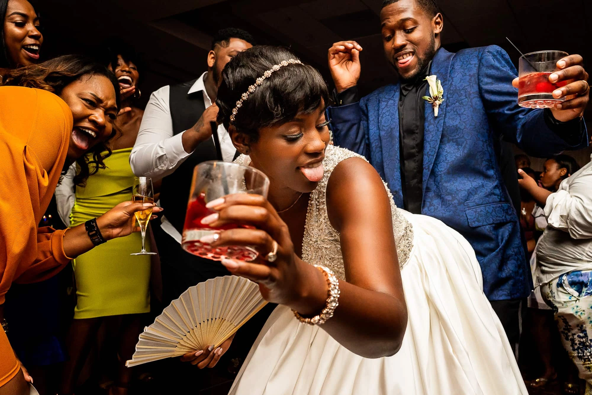 Bride dancing with friends gathered around her