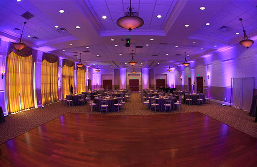 Purple uplighting around a spacious reception room